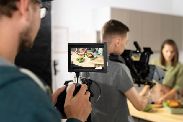 man holding a video camera, shooting b rolls